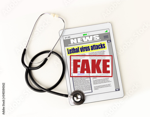 Shot of a stethoscope lying on top of a tablet against a white background