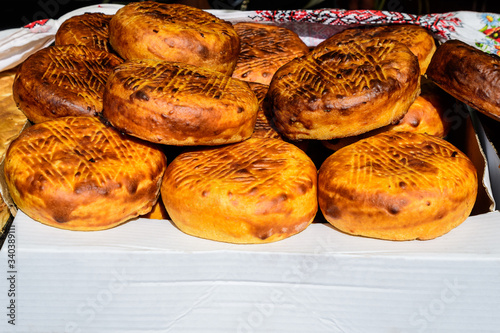 Freshly home baked corn bread displayed for sale on a table at a street food market, side view of healthy food 