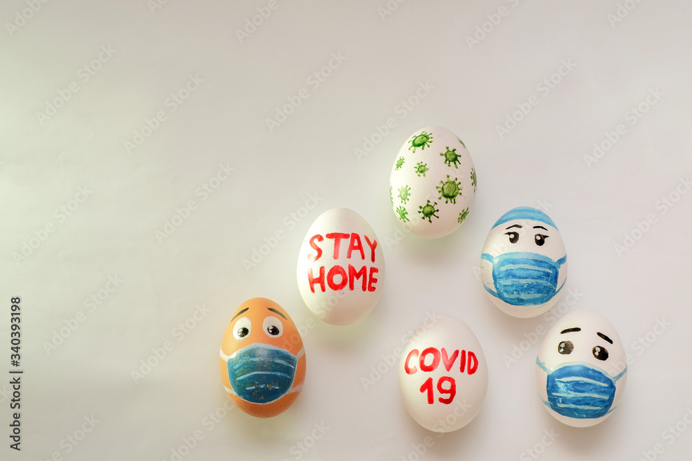 Easter eggs in a basket on a white background with the inscription sit at home