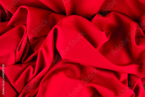 background of red fabric, macro view of fabric texture, concept of sewing and textile production