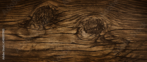 Dark stained wood board with grain knots and texture