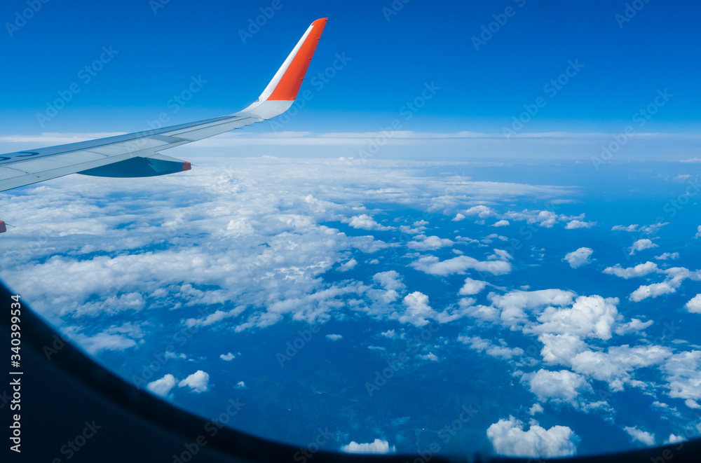 Windows and airplane wings in the blue sky Windows and airplane wings in the blue sky