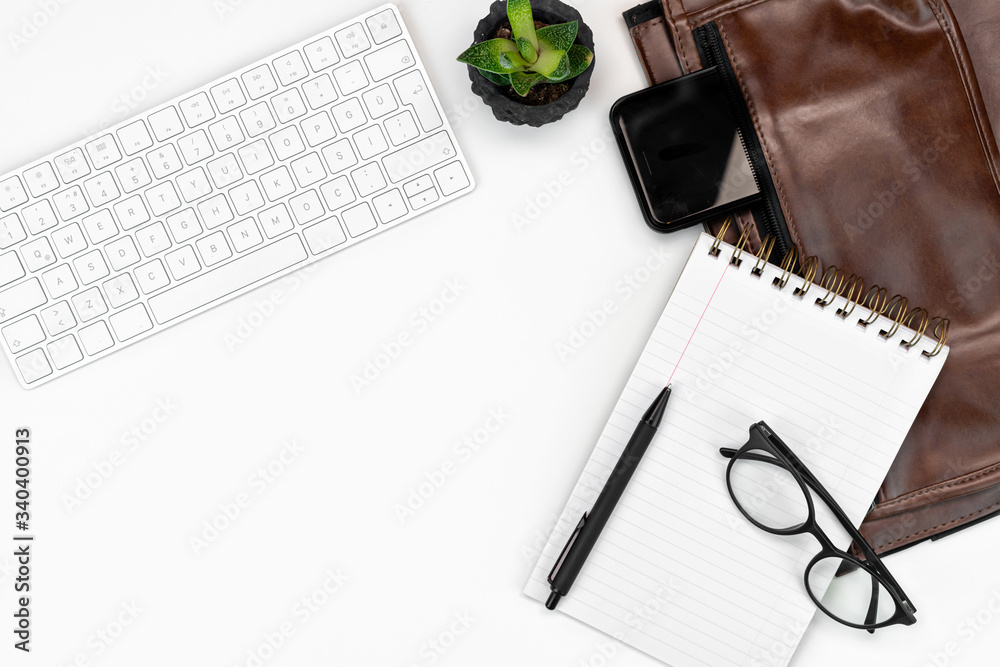 flat-lay White office desk table layout. computer keyboard, glasses, coffee, notebook and laptop case. copy space layout flat-lay White office desk table layout. computer keyboard, glasses, coffee, notebook and laptop case. copy space layout