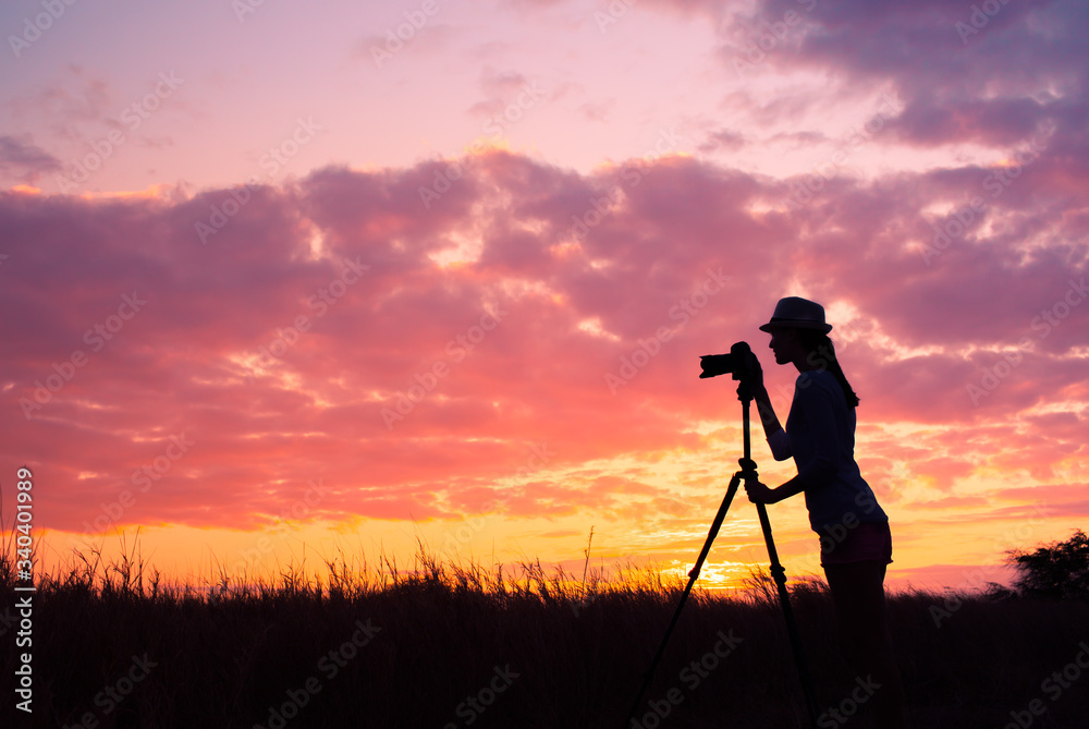 silhouette of photographer at sunset. 