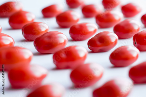 Fresh cherry tomatoes on a white background. Food isolate. Group of fresh tomatoes.