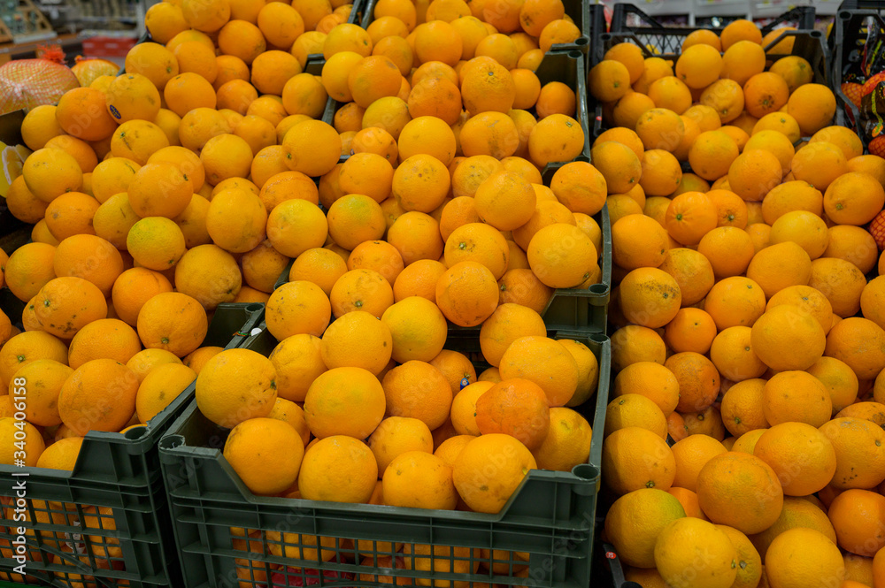ripe tangerines in plastic boxes in a grocery store