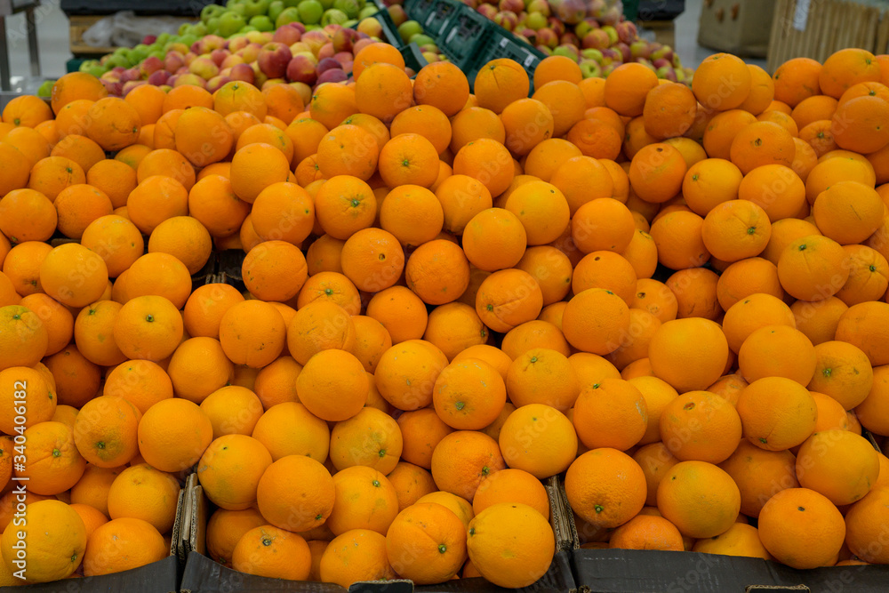 orange tangerines and clementines in plastic boxes in a grocery store