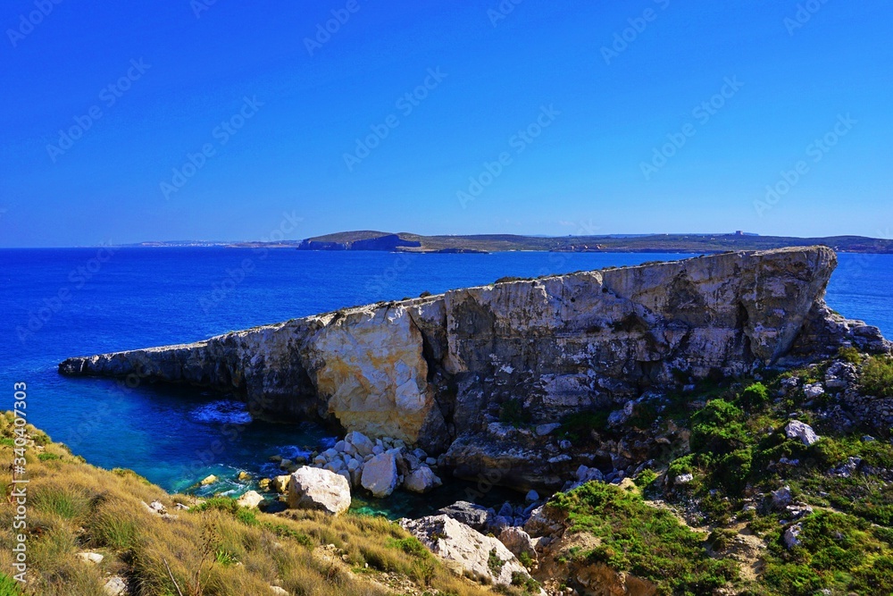 Amazing rocky landscape at the Gozo coastline and turquoise water of Mediterranean Sea