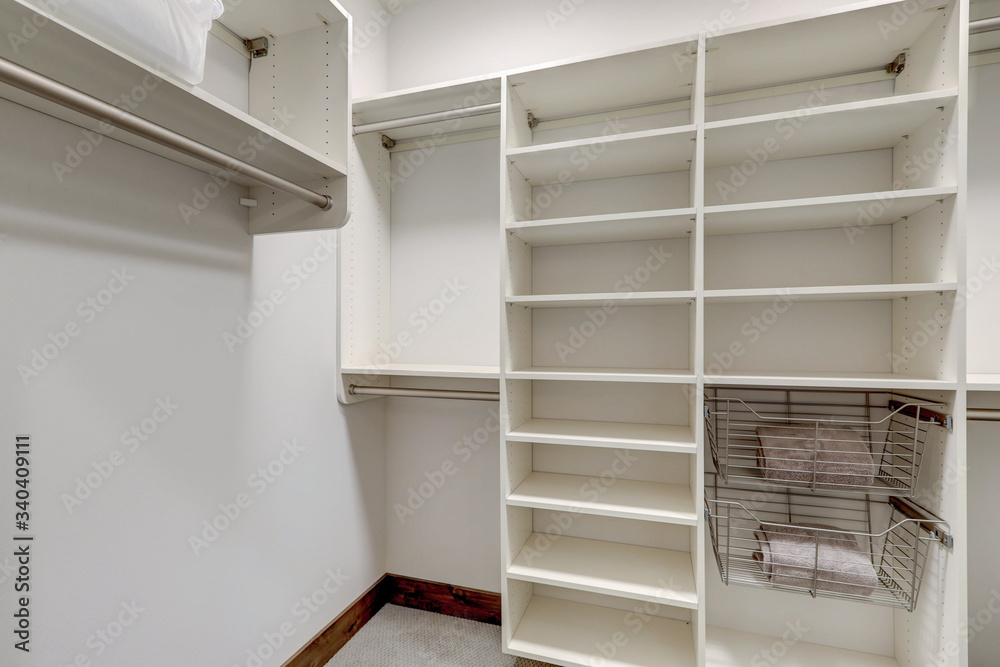 Master bedroom walk in closet with empty white shelves. Master bedroom walk in closet with empty white shelves.