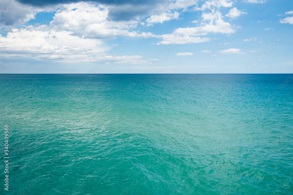 scenery view of transparent water and blue sky with horizont line