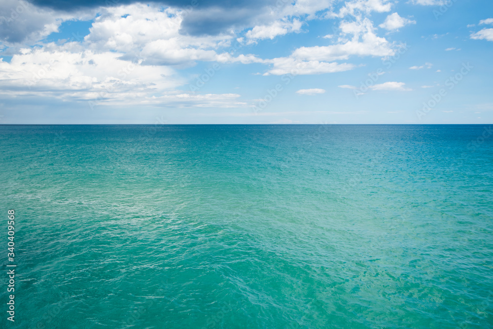 scenery view of transparent water and blue sky with horizont line scenery view of transparent water and blue sky with horizont line