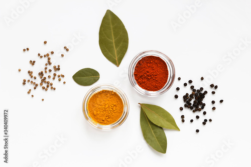 Fototapeta Naklejka Na Ścianę i Meble -  set of assorty colorful spices and herbs in bowls on white background, flat lay, top view