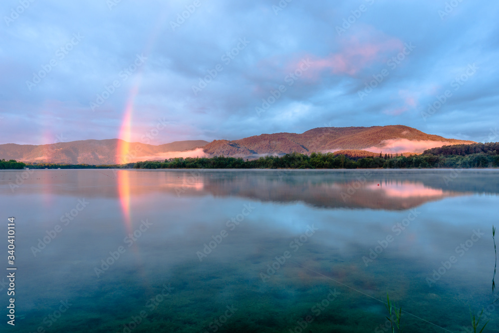 Sunrise rainbow over the lake