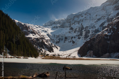 der hintersee im felbertal im spätwinter frühling mit schnee unter blauem himmel  photo