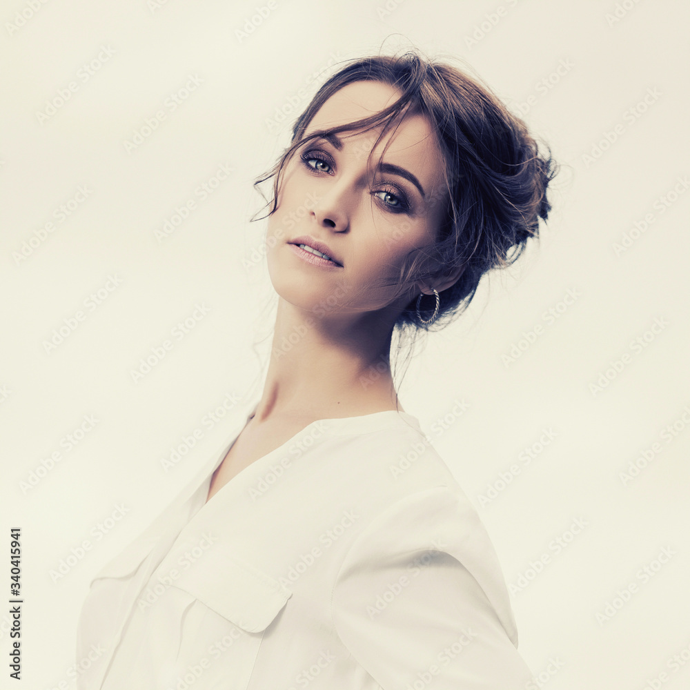 Young fashion business woman in white shirt with bun up do hair Young fashion business woman in white shirt with bun up do hair