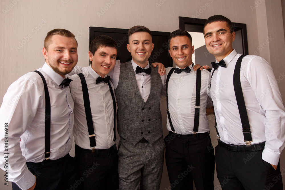 Group portrait of groom and groomsmen. Elegant groom and his friends at wedding day.