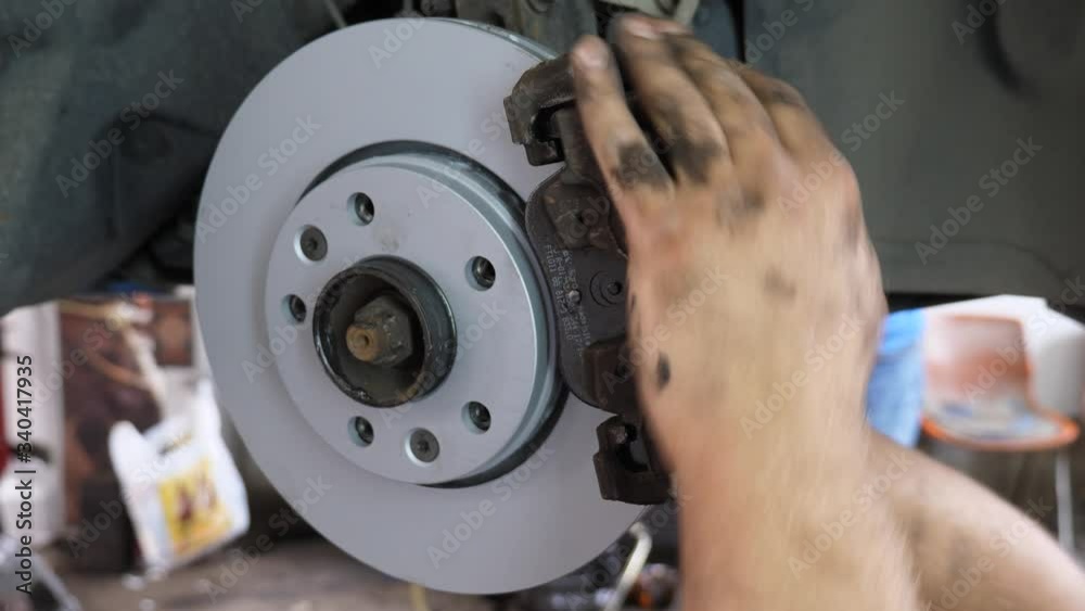 A car mechanic changing the disc brakesbacking plates and brake pads on a carthe shot is
