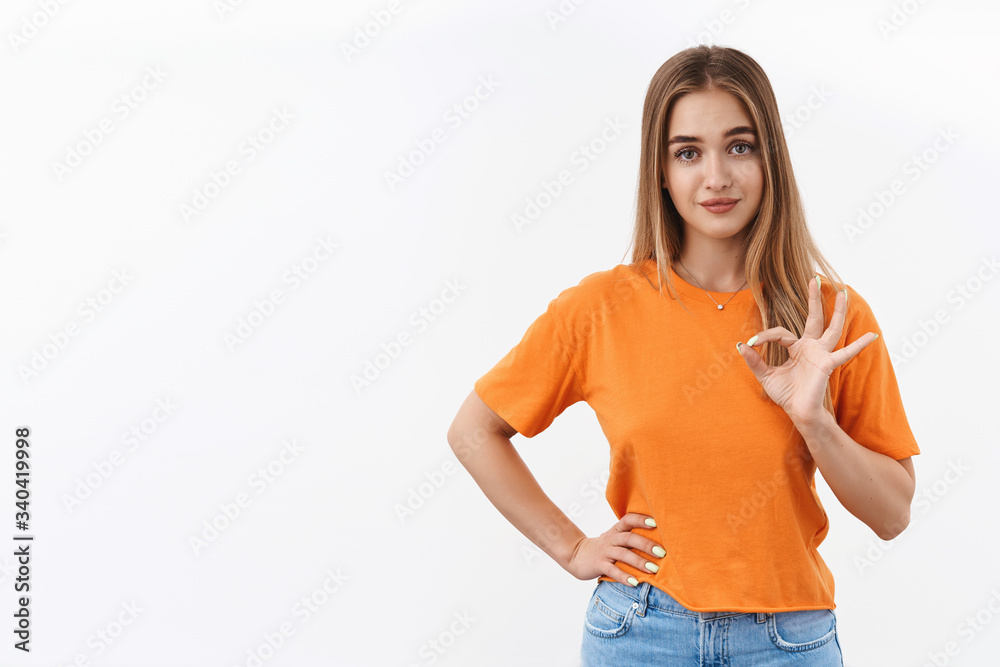 Not the best but good. Portrait of young satisfied blond girl give positive feedback, show okay not bad gesture, rate something average, agree or approve product, standing white background pleased Not the best but good. Portrait of young satisfied blond girl give positive feedback, show okay not bad gesture, rate something average, agree or approve product, standing white background pleased