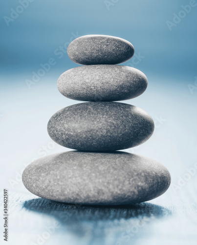 Stack of Zen Stones on blue background.