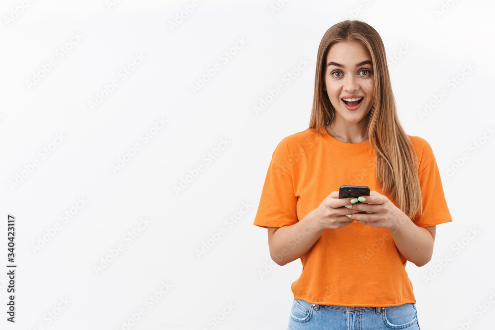 Technology, youth and communication concept. Portrait of beautiful blonde girl using mobile phone, texting friends, using app, recommend download application, upload new content to blog Technology, youth and communication concept. Portrait of beautiful blonde girl using mobile phone, texting friends, using app, recommend download application, upload new content to blog