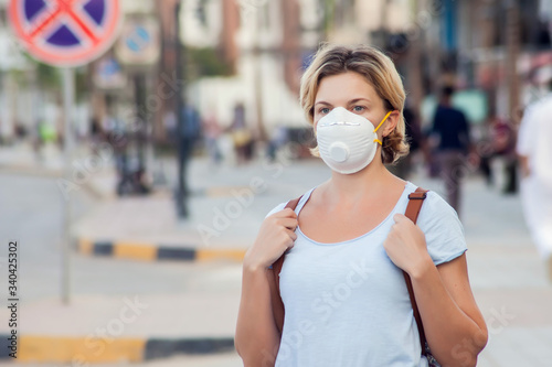 A portrait of woman with face medical mask outdoor. Virus protection concept