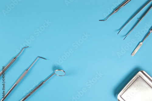 Dental mirrors and probes on a blue background. photo