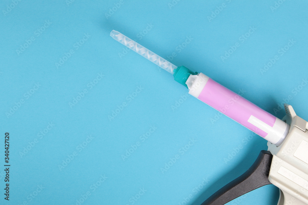 Fototapeta premium Dental gun on a blue background.