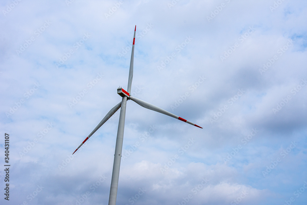 Windmill with the red stripes on a cloudy day Windmill with the red stripes on a cloudy day