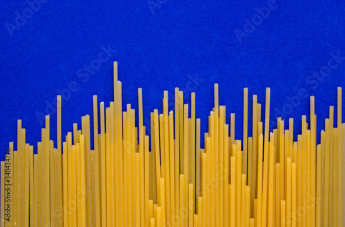 Spaghetti background  yellow paste isolated on blue background