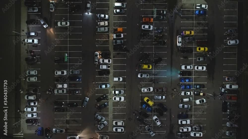 Aerial view from above supermarket (hypermarket or shopping Mall) Parking with cars and motorcyclists at night. snapshot of crowded Parking transport Parking with traffic. Aerial view from above supermarket (hypermarket or shopping Mall) Parking with cars and motorcyclists at night. snapshot of crowded Parking transport Parking with traffic.