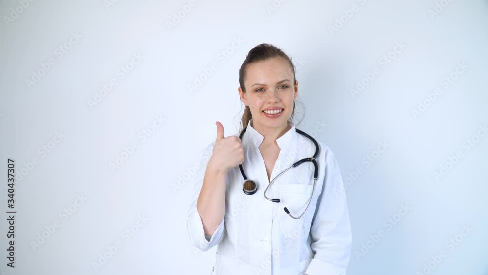 Portrait of a young woman doctor in a white coat with a stethoscope on a white background in a hospital Portrait of a young woman doctor in a white coat with a stethoscope on a white background in a hospital