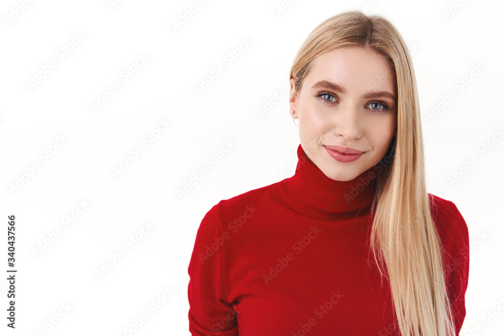 Beauty, women and fashion concept. Close-up portrait of feminine, tender young blonde woman in red turtleneck, looking camera with thoughtful seducing expression, white background Beauty, women and fashion concept. Close-up portrait of feminine, tender young blonde woman in red turtleneck, looking camera with thoughtful seducing expression, white background