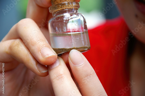 A little bottle with panned off sand and dirt and gold
