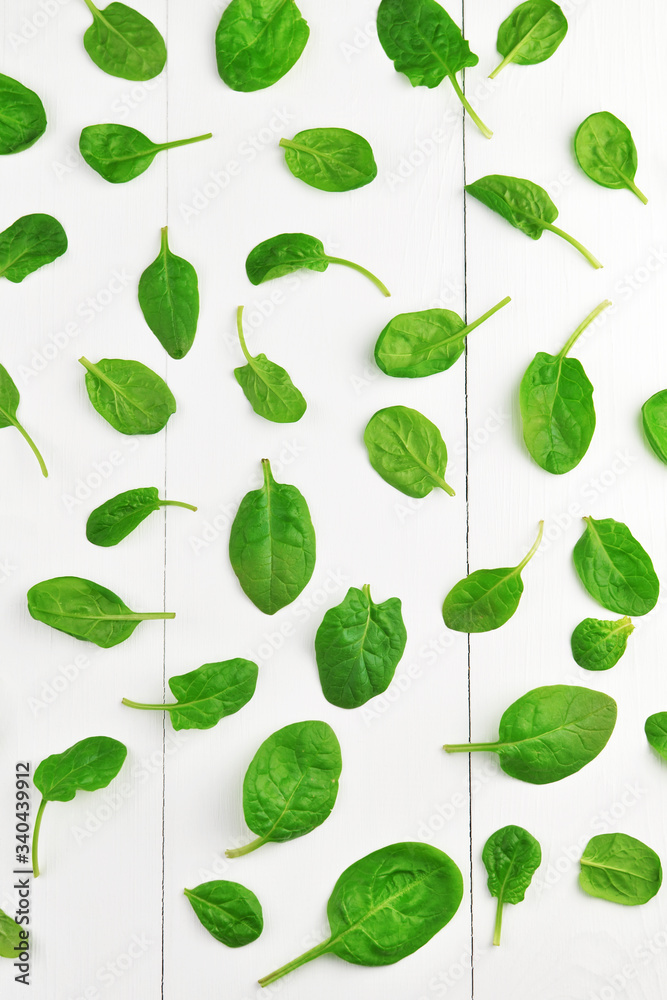 Spinach leaves on white wooden table background. Healthy vegan food trend. Green living concept. Top view. Spinach leaves on white wooden table background. Healthy vegan food trend. Green living concept. Top view.