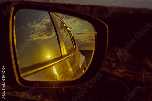Reflection of the road in the mirror of a car closeup. © Igor Ushakov