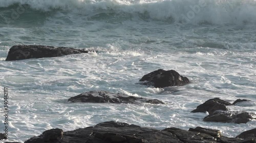 Slow motion lockdown shot of stunning waves crashing on rocky shore  - Cape Town, South Africa