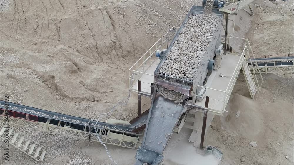 Quarry With Equipment For Processing Stone Falling From A Moving Conveyor Belt Quarry With Equipment For Processing Stone Falling From A Moving Conveyor Belt