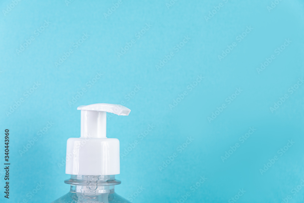 Container with alcohol gel on the light blue background Container with alcohol gel on the light blue background