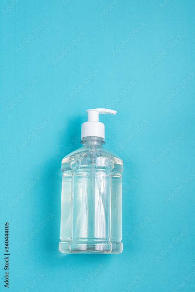 Container with alcohol gel on the light blue background Container with alcohol gel on the light blue background