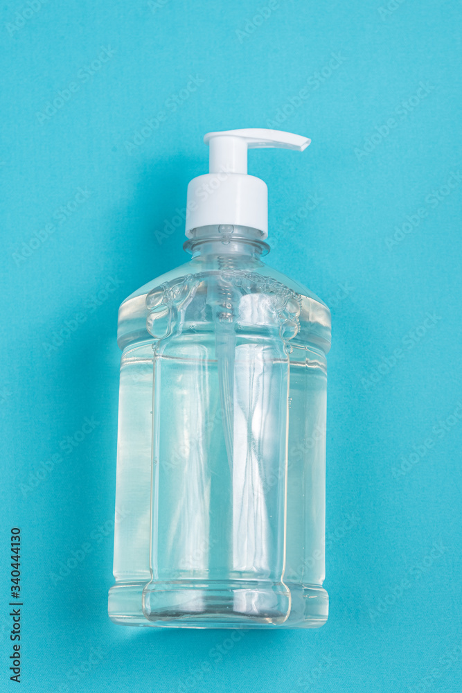 Container with alcohol gel on the light blue background Container with alcohol gel on the light blue background