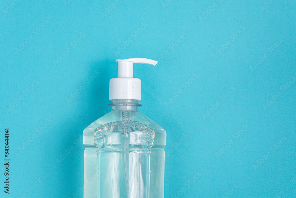 Container with alcohol gel on the light blue background