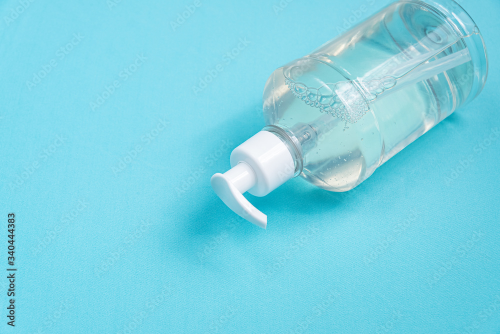 Container with alcohol gel on the light blue background Container with alcohol gel on the light blue background