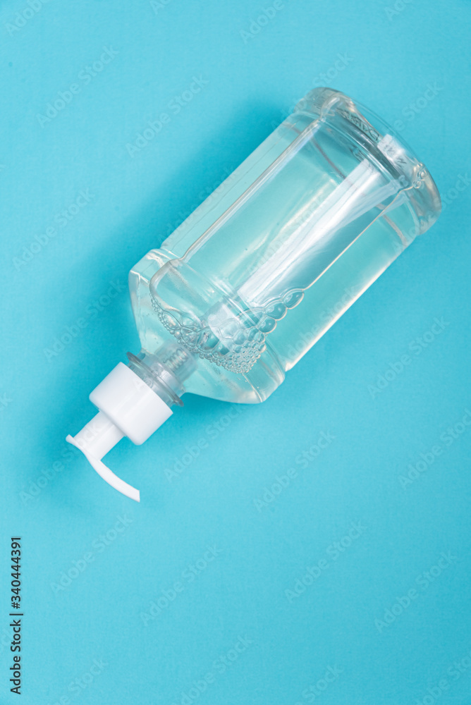 Container with alcohol gel on the light blue background Container with alcohol gel on the light blue background