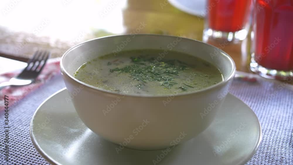 Fresh sour pickle soup bowl served at a restaurant in Eastern Europe Fresh sour pickle soup bowl served at a restaurant in Eastern Europe