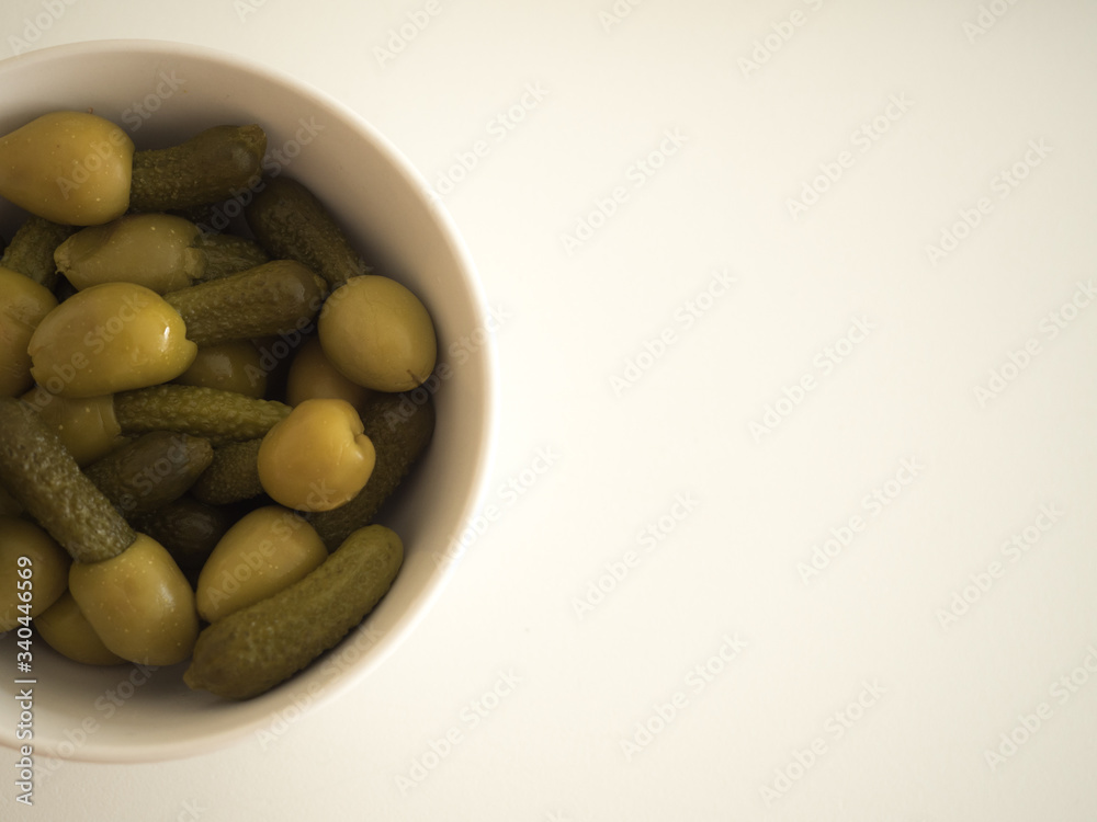 white bowl of green olives stuffed with pickle white bowl of green olives stuffed with pickle