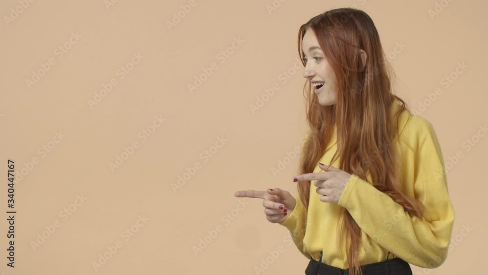 Gorgreous redhead girl, long natural ginger hair, turn face left at blank empty space for promo, found interesting awesome offer, look you and show thumb-up, recommend, approve and like concept Gorgreous redhead girl, long natural ginger hair, turn face left at blank empty space for promo, found interesting awesome offer, look you and show thumb-up, recommend, approve and like concept