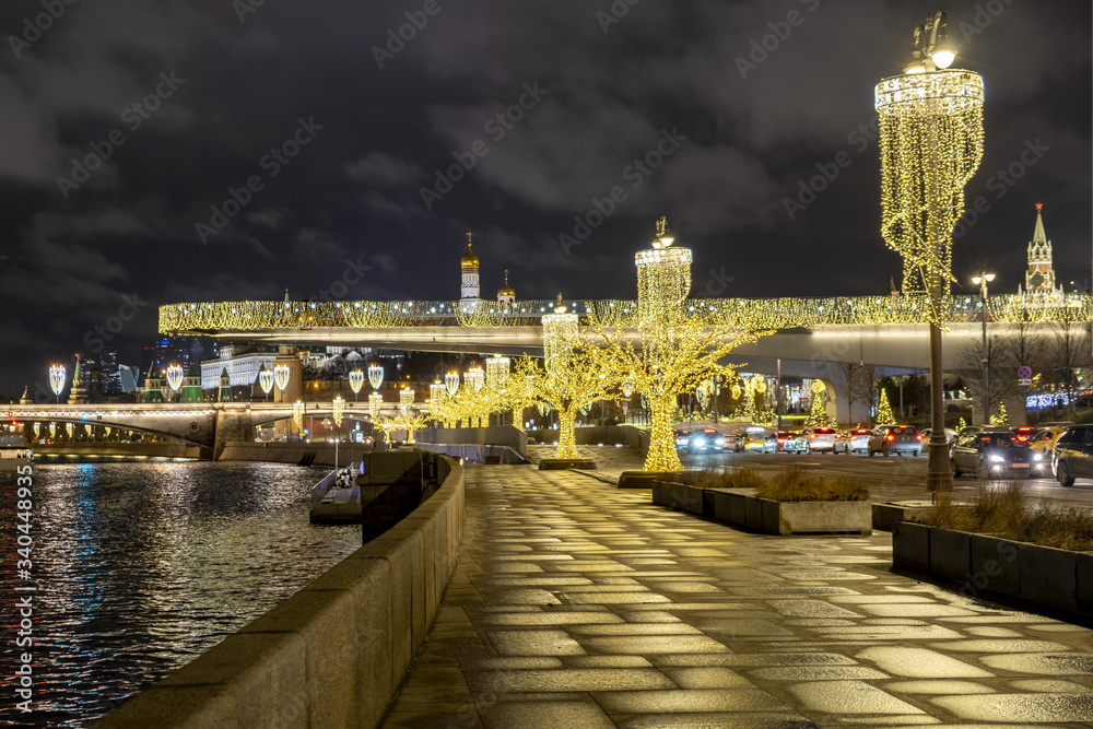 View of Zaryadye Park, soaring bridge over the Moscow river, the Kremlin and Pokrovsky Cathedral on new year and Christmas holidays in the evening - Moscow, Russia, 17 01 2020