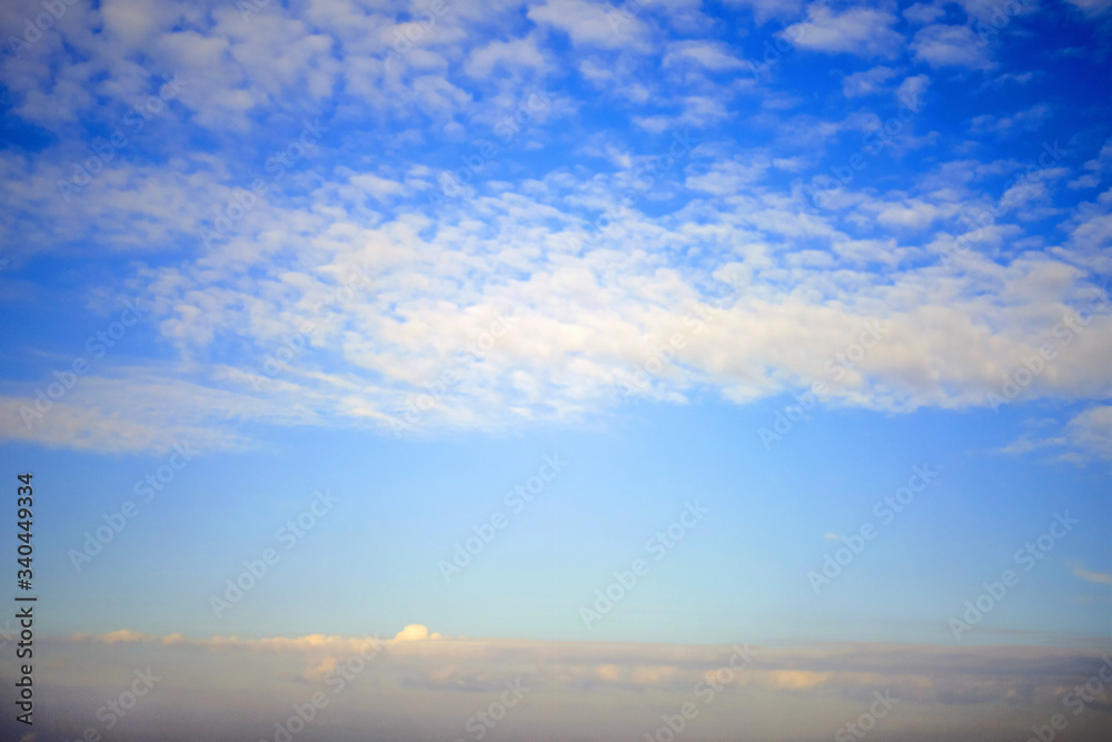 Feather and cumulus clouds on the sky, background, copy space for text