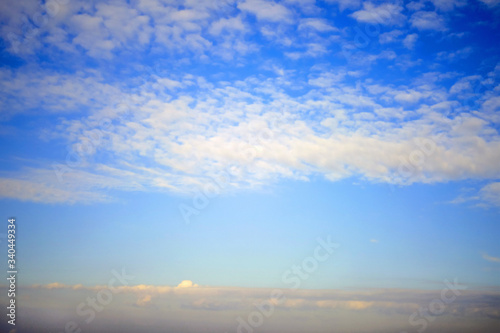 Feather and cumulus clouds on the sky  background  copy space for text