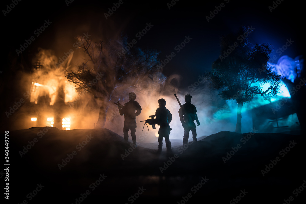 Fototapeta premium War Concept. Military silhouettes fighting scene on war fog sky background, World War Soldiers Silhouette Below Cloudy Skyline At night.